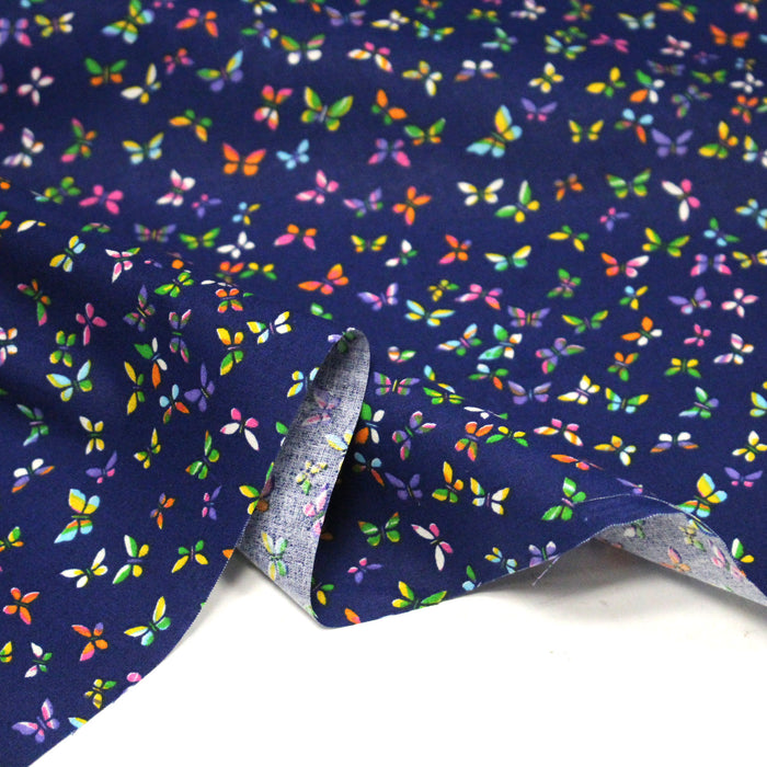 Tissu cotonnade bleue aux papillons multicolores - OEKO-TEX STANDARD 100