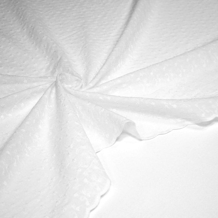 Tissu broderie anglaise fleurie 100% coton blanc, à double feston