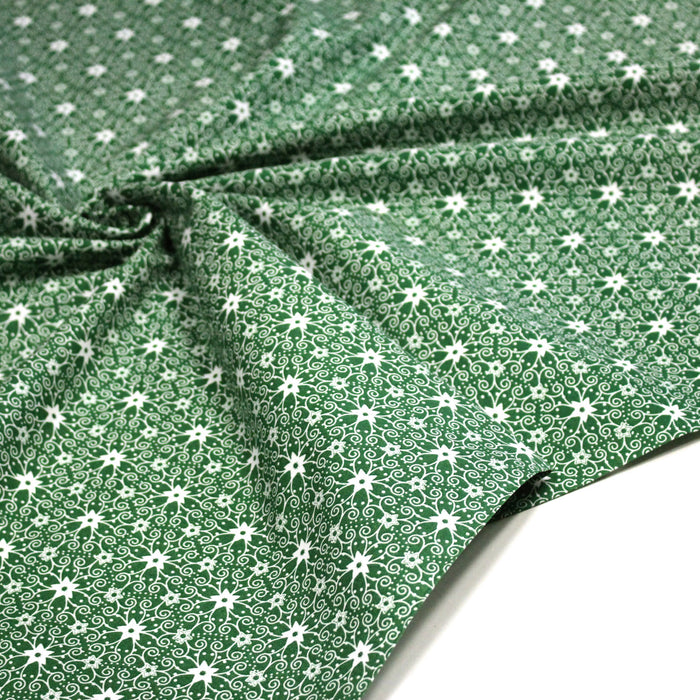 Tissu de Noël cotonnade vert aux motifs géométriques blancs de Noël
