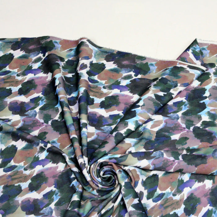 Tissu jersey scuba habillement motif multicolore aux tons bleus verts et violets