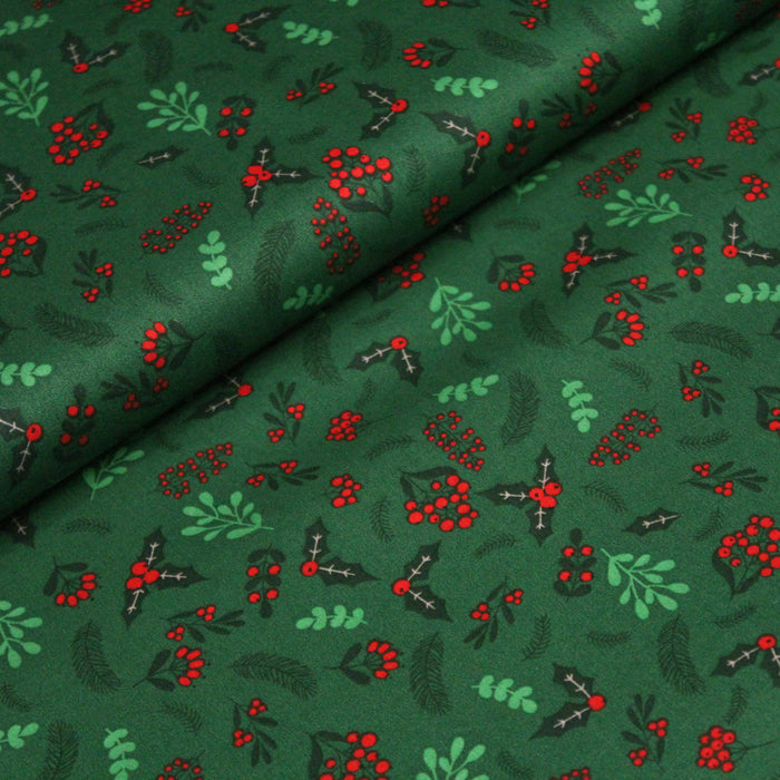 Tissu de coton de Noël vert aux feuilles de houx vertes et branches de sapins verts - COLLECTION NOËL - OEKO - TEX - TissusPapi.com