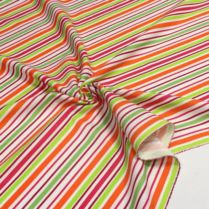 Tissu Bayadère de coton aux rayures oranges, rouges et roses, fond blanc - TissusPapi.com