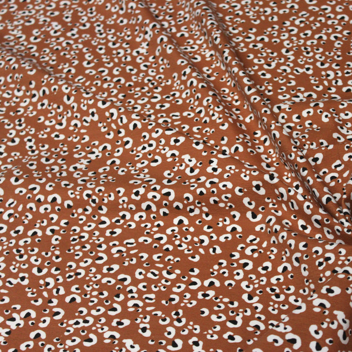 Tissu jersey de coton motif Léopard noir & blanc, fond marron rouille - OEKO-TEX
