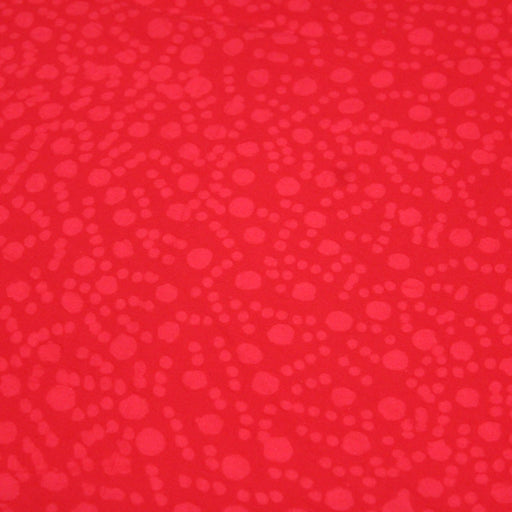 Tissu de coton batik gaufré OCÉANIE aux fleurs et taches rouges clair, fond rouge - TissusPapi.com