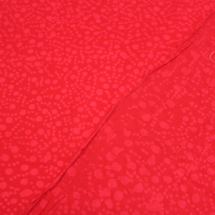 Tissu de coton batik gaufré OCÉANIE aux fleurs et taches rouges clair, fond rouge - TissusPapi.com