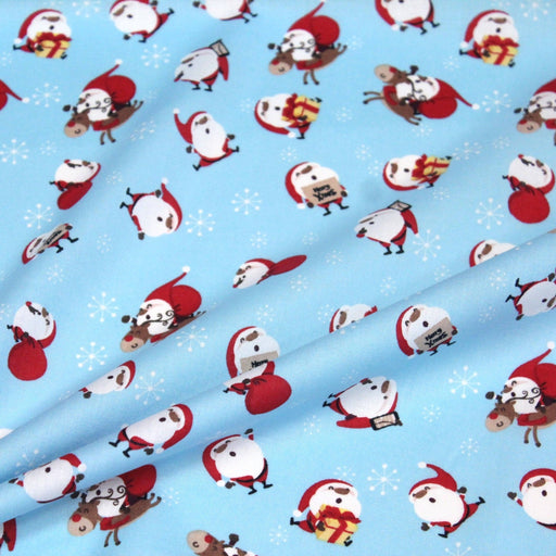 Tissu popeline de coton de Noël - Le père Noël, fond bleu ciel - TissusPapi.com