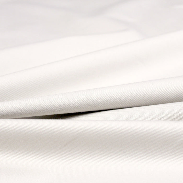 Tissu Gabardine de coton élasthanne - sergé de coton élasthanne blanc cassé uni
