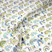 Tissu popeline coton blanc aux arcs en ciel verts bleus et jaunes - TissusPapi.com