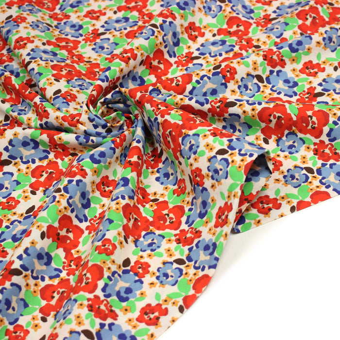 Tissu cotonnade aux fleurs graphiques rouges, bleues, vertes, fond écru - OEKO-TEX STANDARD 100