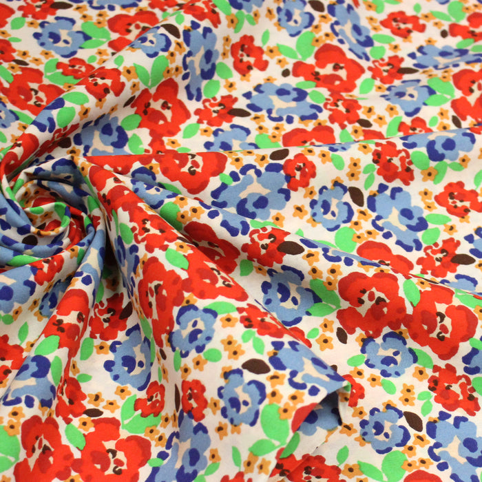 Tissu cotonnade aux fleurs graphiques rouges, bleues, vertes, fond écru - OEKO-TEX STANDARD 100