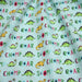 Tissu popeline coton DINO ROAR, bleu aux motifs dinosaures multicolores - TissusPapi.com