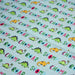 Tissu popeline coton DINO ROAR, bleu aux motifs dinosaures multicolores - TissusPapi.com
