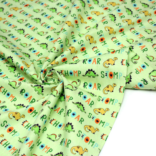 Tissu popeline coton DINO ROAR, vert aux motifs dinosaures multicolores - TissusPapi.com
