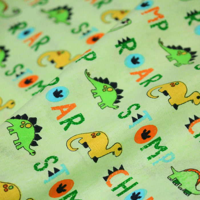 Tissu popeline coton DINO ROAR, vert aux motifs dinosaures multicolores - TissusPapi.com