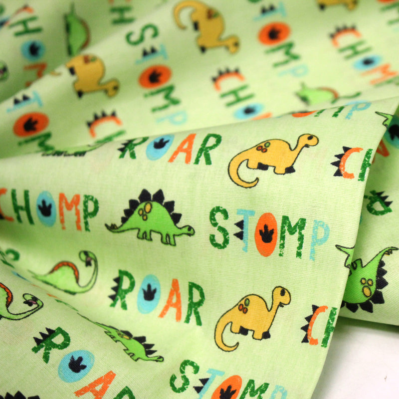 Tissu popeline coton DINO ROAR, vert aux motifs dinosaures multicolores - TissusPapi.com