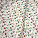 Tissu popeline coton DINO ROAR, blanc aux motifs dinosaures multicolores - TissusPapi.com
