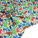 Tissu popeline coton bleu ciel aux dinosaures multicolores - TissusPapi.com