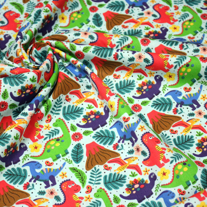 Tissu popeline coton bleu ciel aux dinosaures multicolores - TissusPapi.com