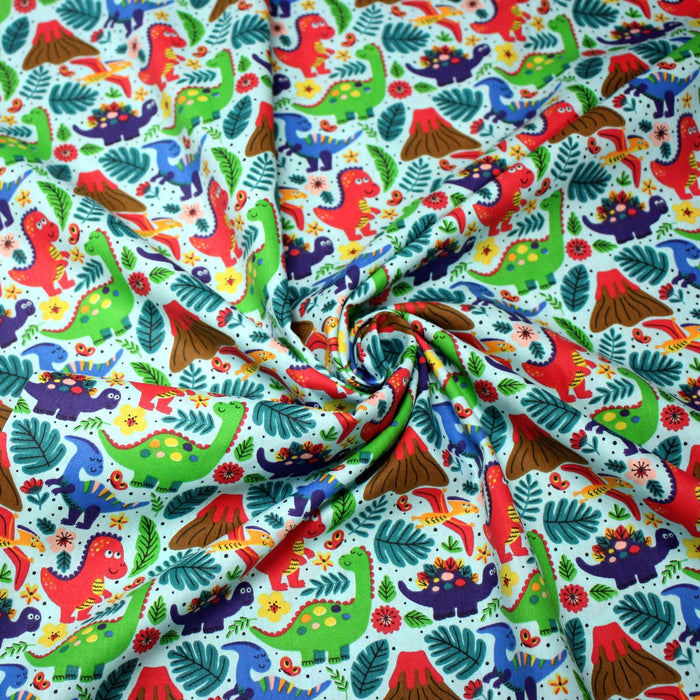 Tissu popeline coton bleu ciel aux dinosaures multicolores - TissusPapi.com