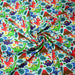 Tissu popeline coton bleu ciel aux dinosaures multicolores - TissusPapi.com