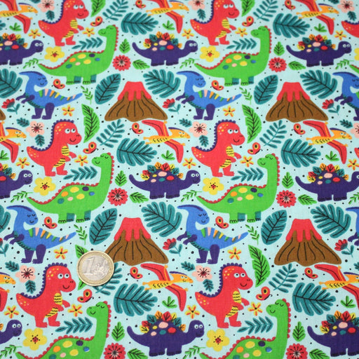 Tissu popeline coton bleu ciel aux dinosaures multicolores - TissusPapi.com