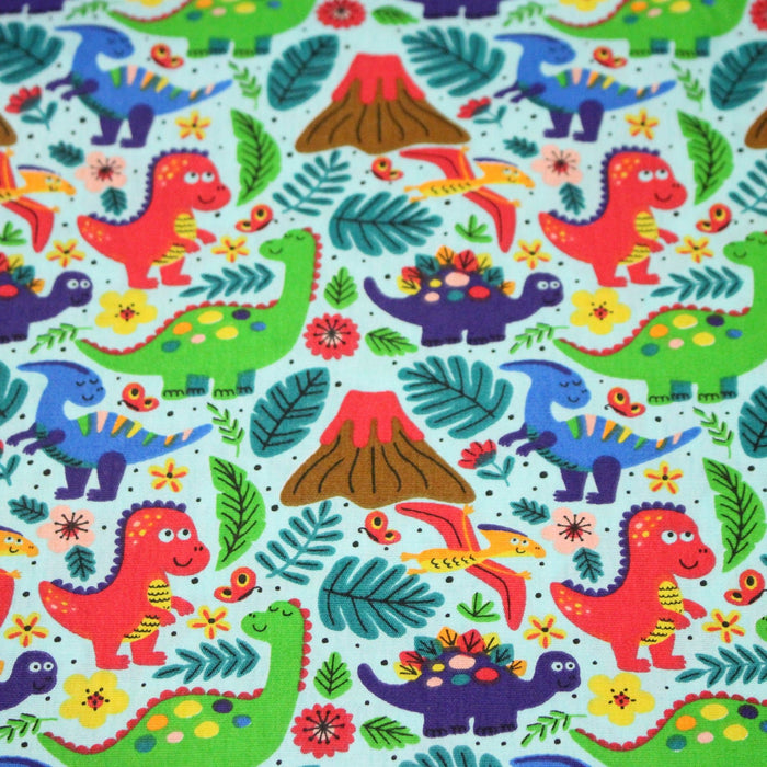 Tissu popeline coton bleu ciel aux dinosaures multicolores - TissusPapi.com