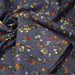 Tissu popeline coton bleu aux fins pois noirs et fines fleurs multicolores - TissusPapi.com