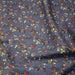 Tissu popeline coton bleu aux fins pois noirs et fines fleurs multicolores - TissusPapi.com