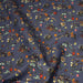 Tissu popeline coton bleu aux fins pois noirs et fines fleurs multicolores - TissusPapi.com
