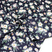 Tissu popeline coton bleu aux marguerites blanches et jaunes - TissusPapi.com