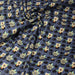 Tissu popeline coton bleu aux coeurs noirs et petits fleurs multicolores - TissusPapi.com