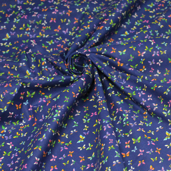 Tissu cotonnade bleue aux papillons multicolores - OEKO-TEX STANDARD 100