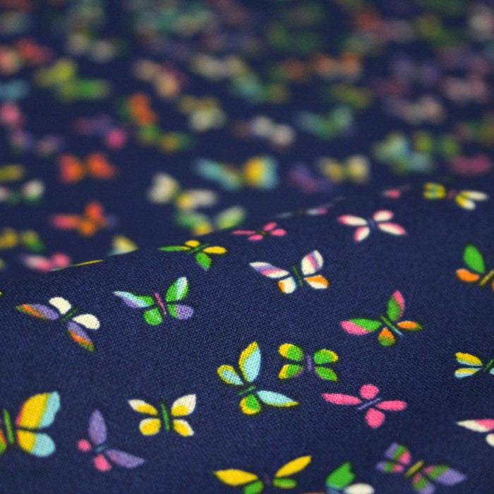 Tissu cotonnade bleue aux papillons multicolores - OEKO-TEX STANDARD 100