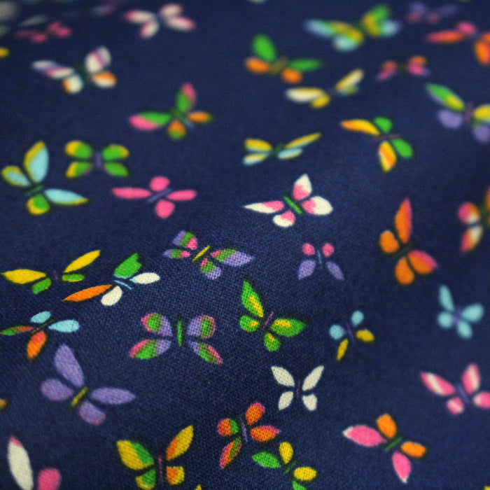 Tissu cotonnade bleue aux papillons multicolores - OEKO-TEX STANDARD 100