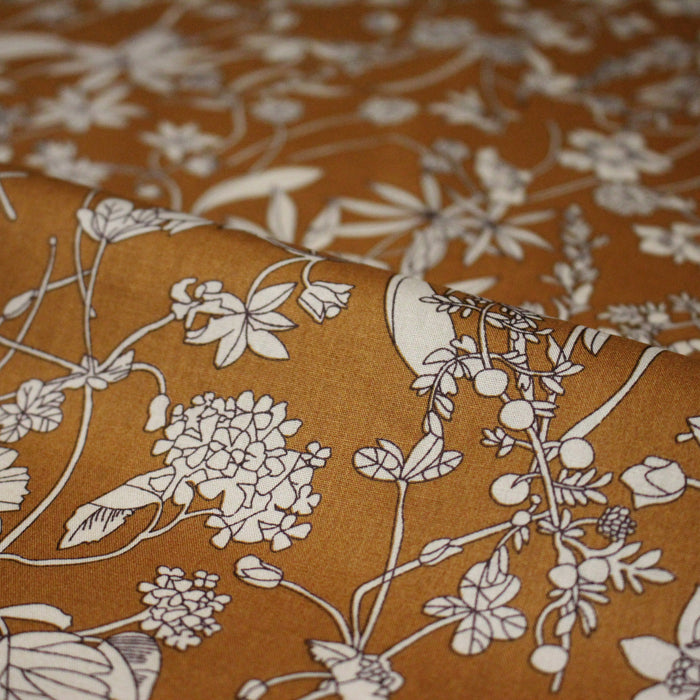 Tissu popeline de coton ocre aux fines fleurs et feuilles écrues - COLLECTION FLORALE