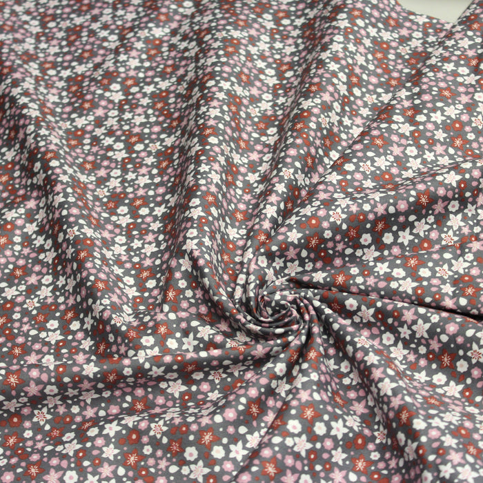 Tissu popeline de coton fleuri gris aux fleurs roses, rouille et blanches