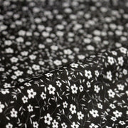 Tissu cotonnade noir aux fleurs blanches - OEKO - TEX - TissusPapi.com