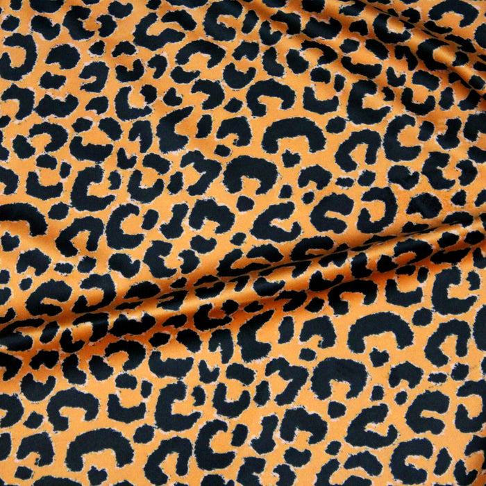 Tissu Velours ras motif léopard noir fond jaune safran