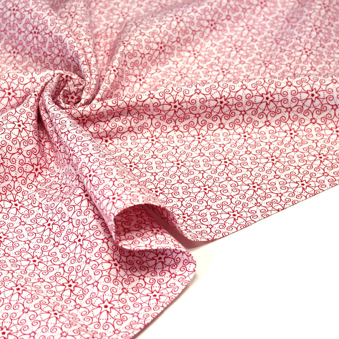 Tissu de Noël cotonnade blanc aux motifs géométriques rouges de Noël