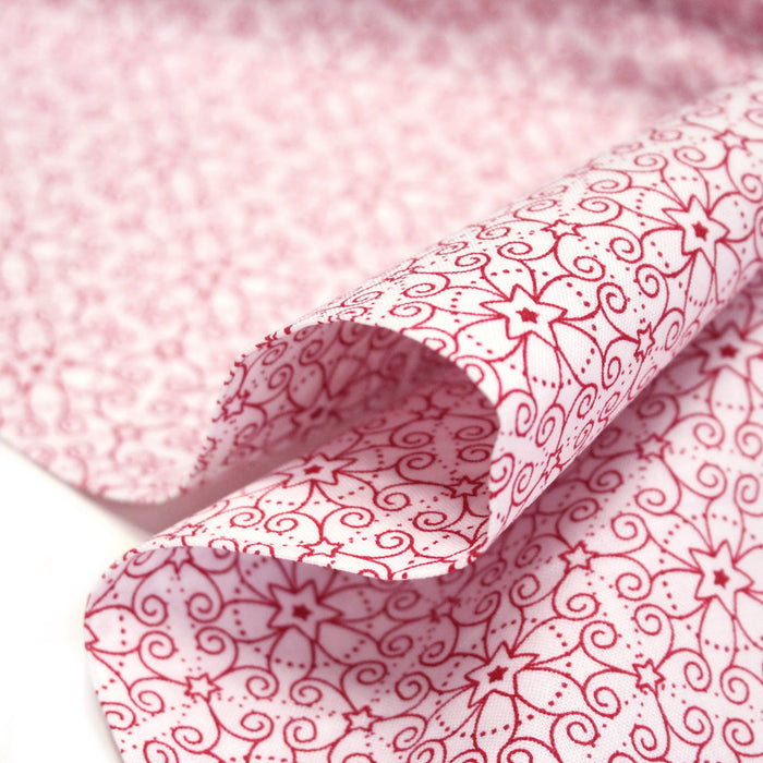 Tissu de Noël cotonnade blanc aux motifs géométriques rouges de Noël