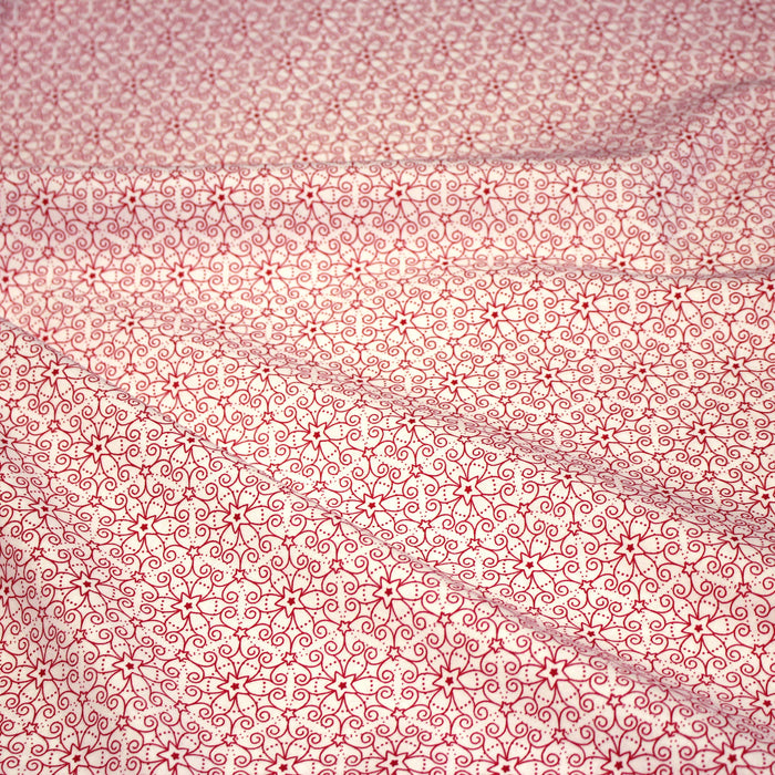 Tissu de Noël cotonnade blanc aux motifs géométriques rouges de Noël