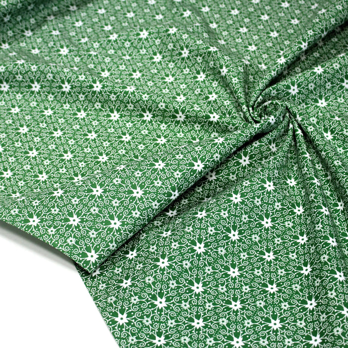 Tissu de Noël cotonnade vert aux motifs géométriques blancs de Noël