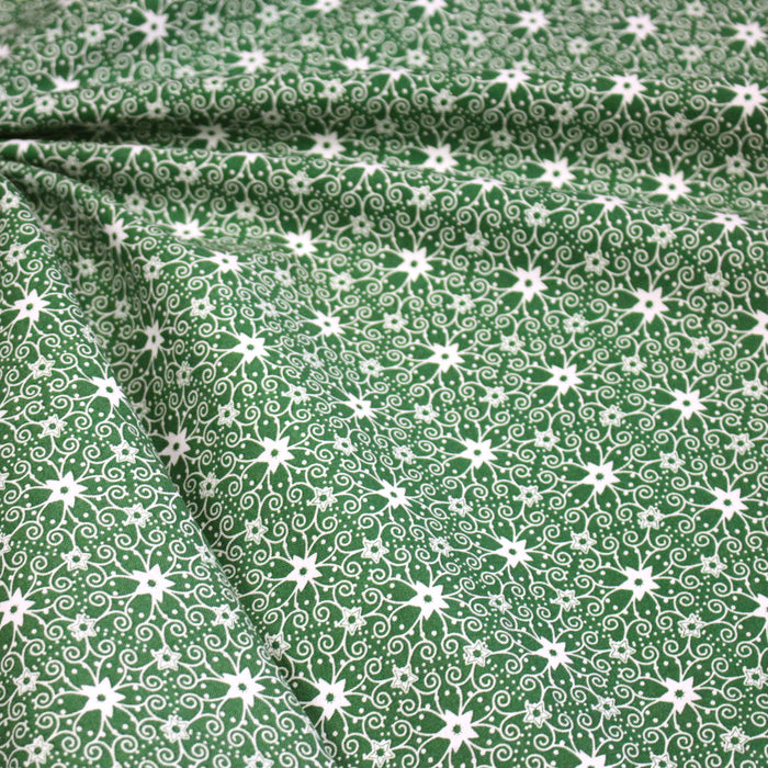 Tissu de Noël cotonnade vert aux motifs géométriques blancs de Noël