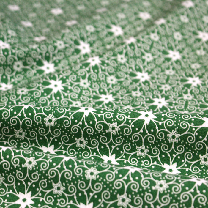 Tissu de Noël cotonnade vert aux motifs géométriques blancs de Noël