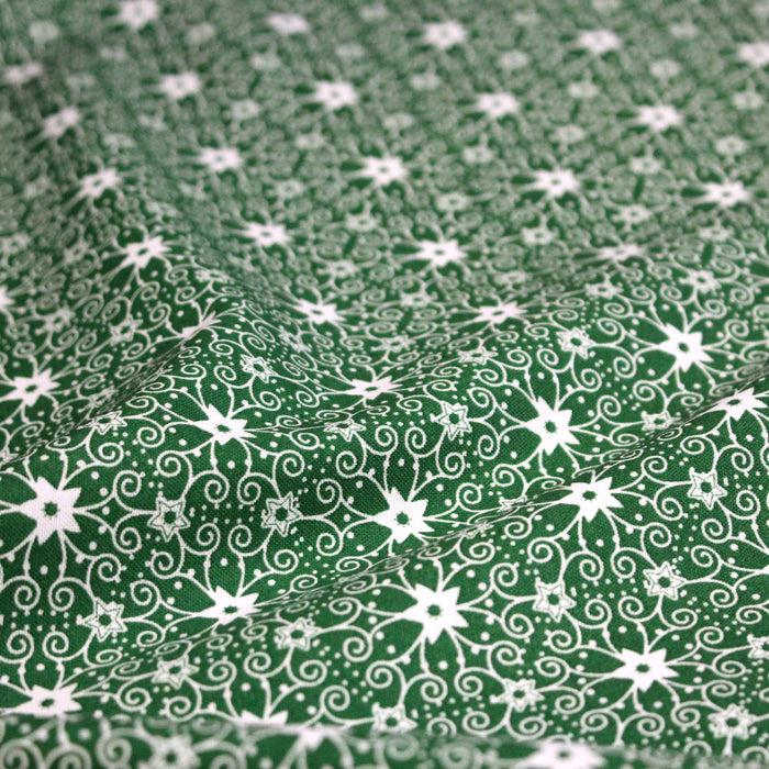 Tissu de Noël cotonnade vert aux motifs géométriques blancs de Noël