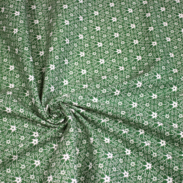 Tissu de Noël cotonnade vert aux motifs géométriques blancs de Noël