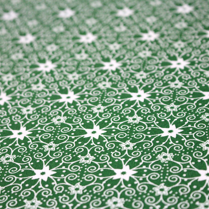 Tissu de Noël cotonnade vert aux motifs géométriques blancs de Noël