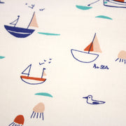 Tissu cotonnade blanc aux petits bateaux bleus et oranges - STANDARD 100 OEKO - TEX - TissusPapi.com