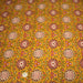 Tissu coton fin imprimé INDIENNES, jaune safran, rosaces rouges et écrues – STANDARD 100 OEKO - TEX - TissusPapi.com
