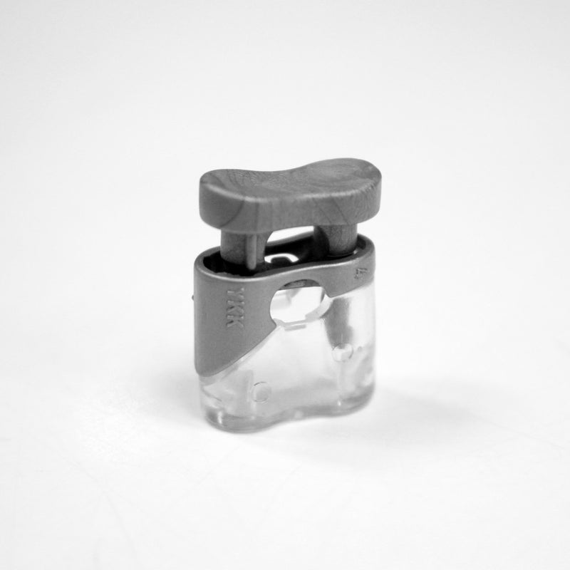 Bloque cordon YKK - Stop cordon gris clair & transparent, 1 trou, YKK - TissusPapi.com